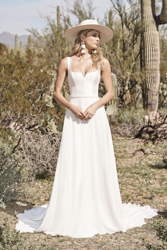 model is wearing a sleeveless a-line bridal gown