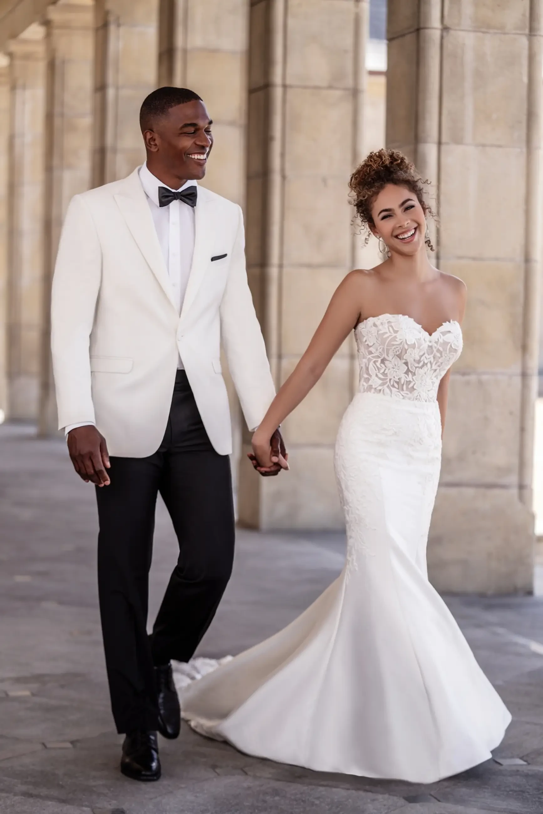 Model is wearing a strapless fit-and-flare gown made from sleek stretch Mikado.