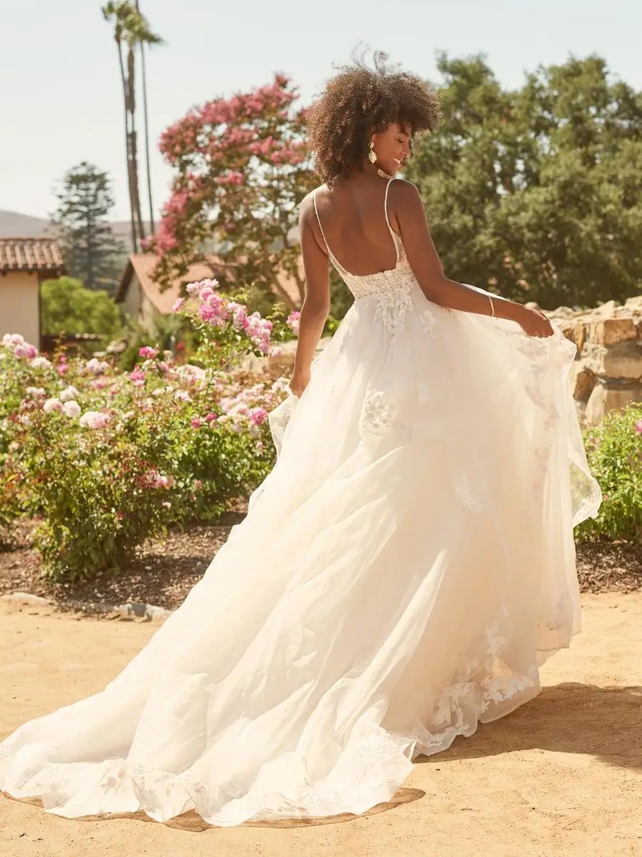 Model is wearing a lace bridal gown by maggie sottero