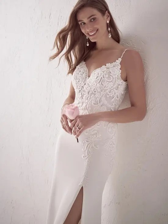 Model is wearing a chiffon sleeveless wedding dress by maggie sottero