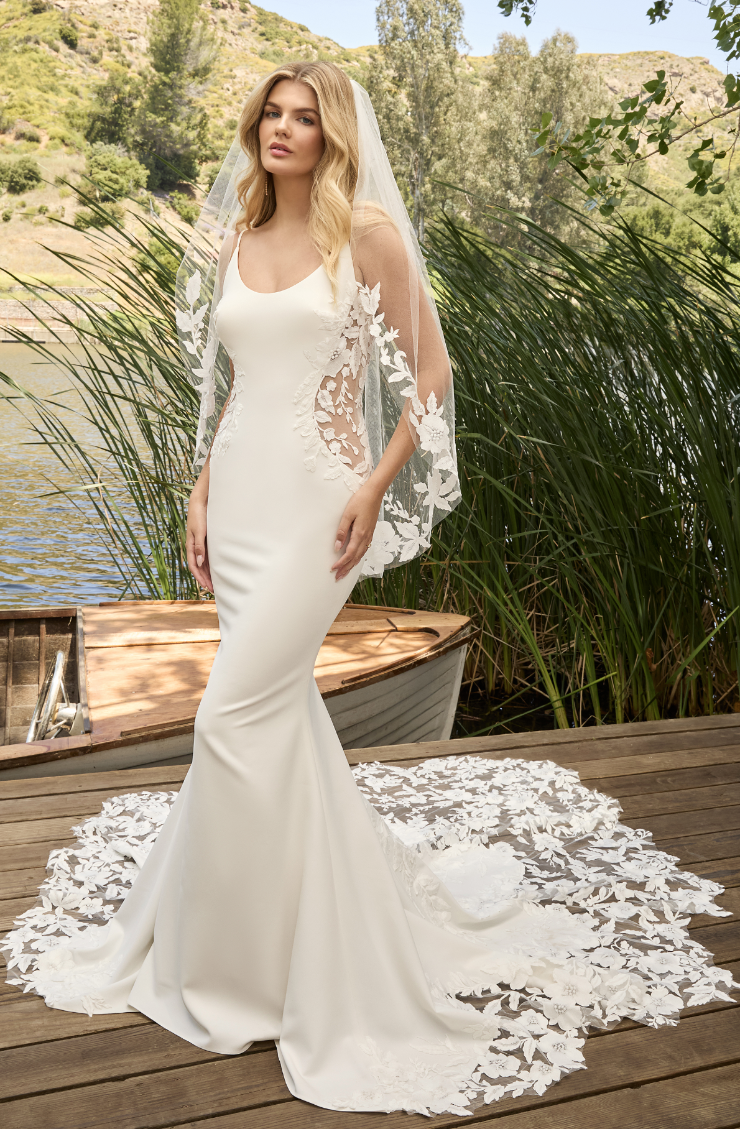 model is wearing a fit and flare bridal gown
