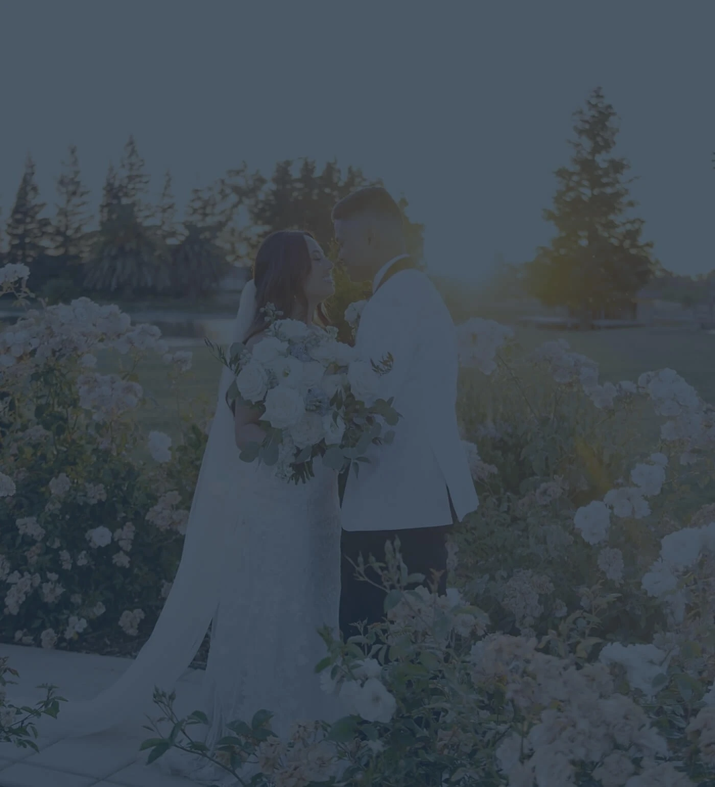 Сouple wearing a white gown and a white suit