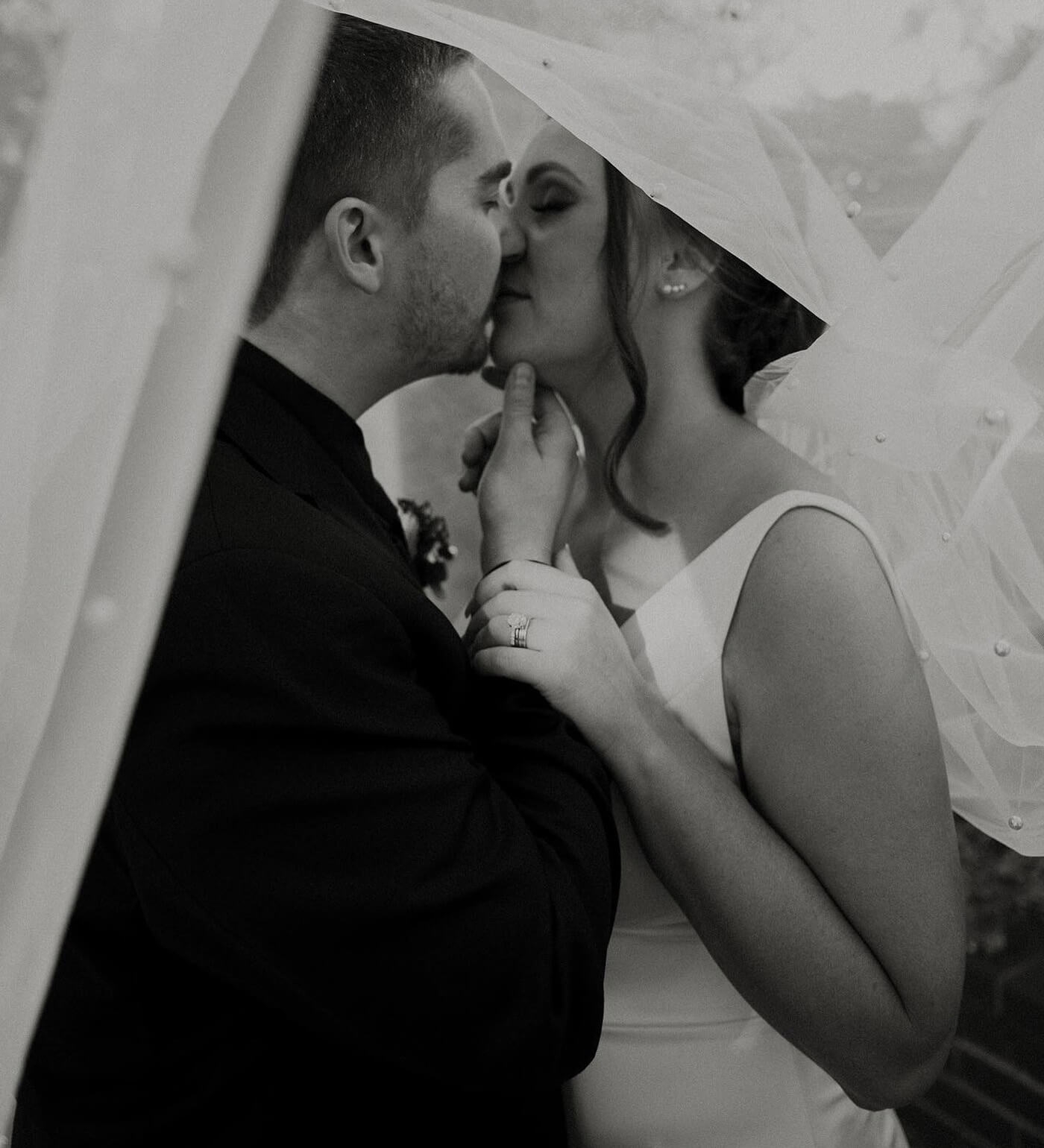 Сouple wearing a white gown and a black suit