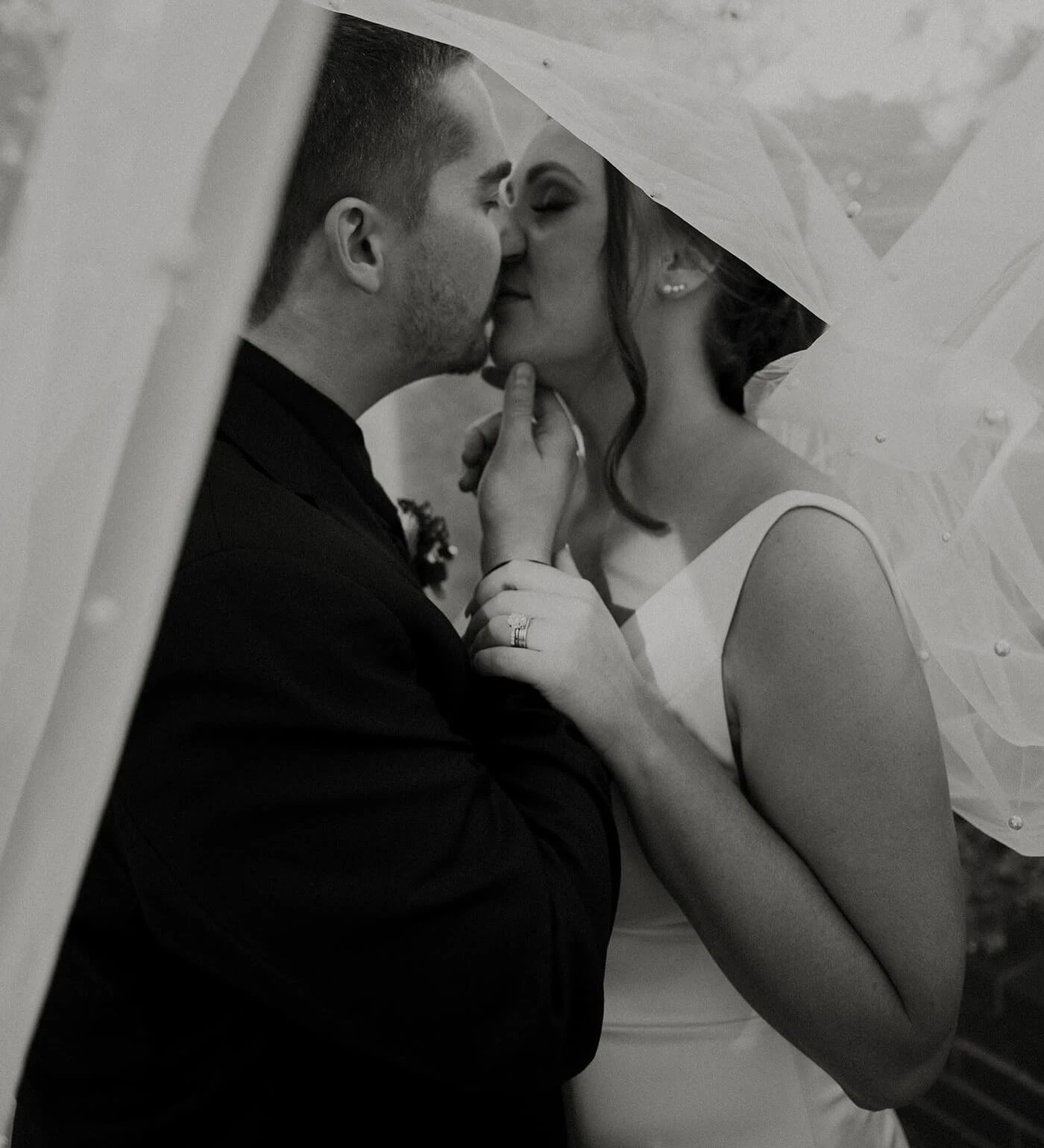 Сouple wearing a white gown and a black suit